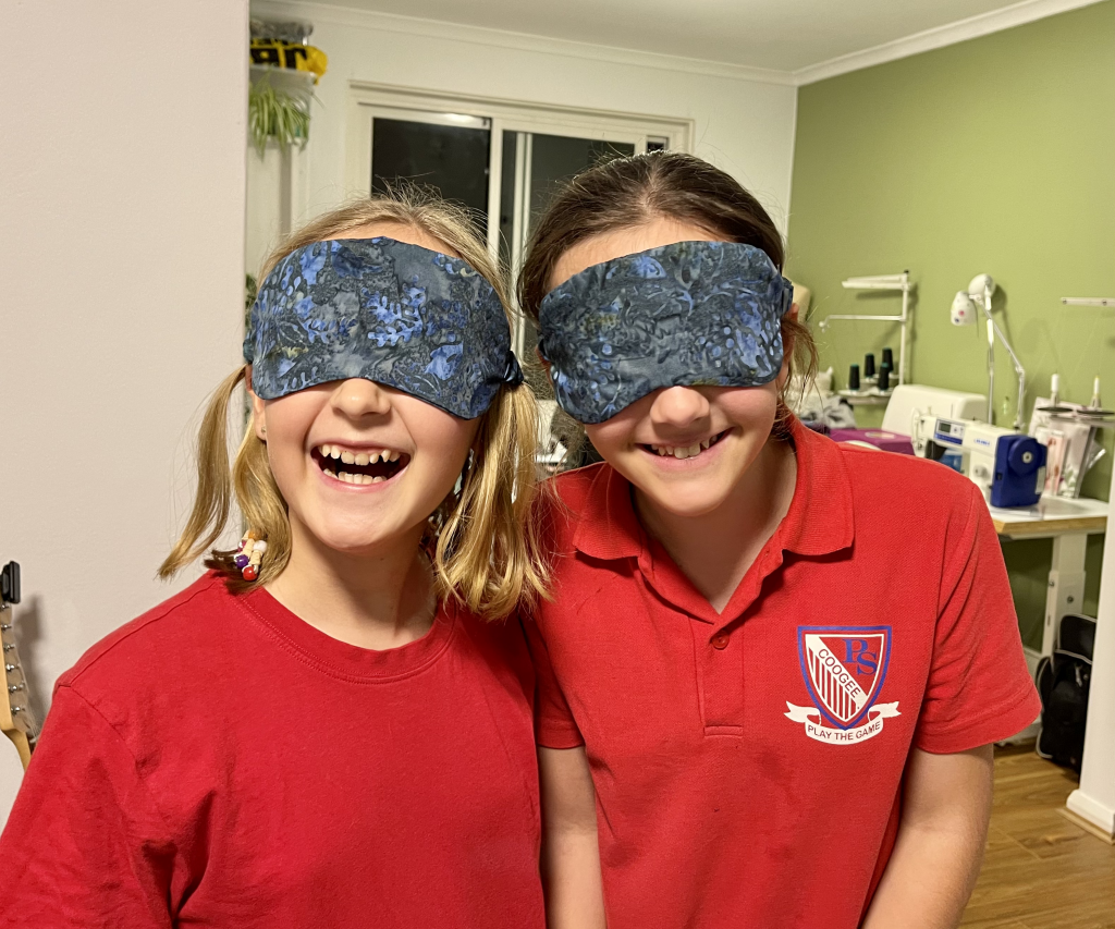 Course participant smiling with sewed sleep masks on their eyes