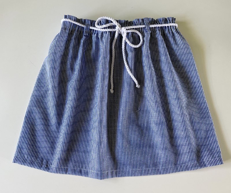 Blue and white skirt with white rope belt.